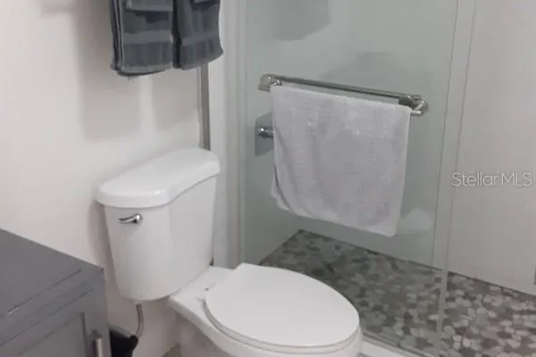 a white toilet sitting next to a bathroom sink