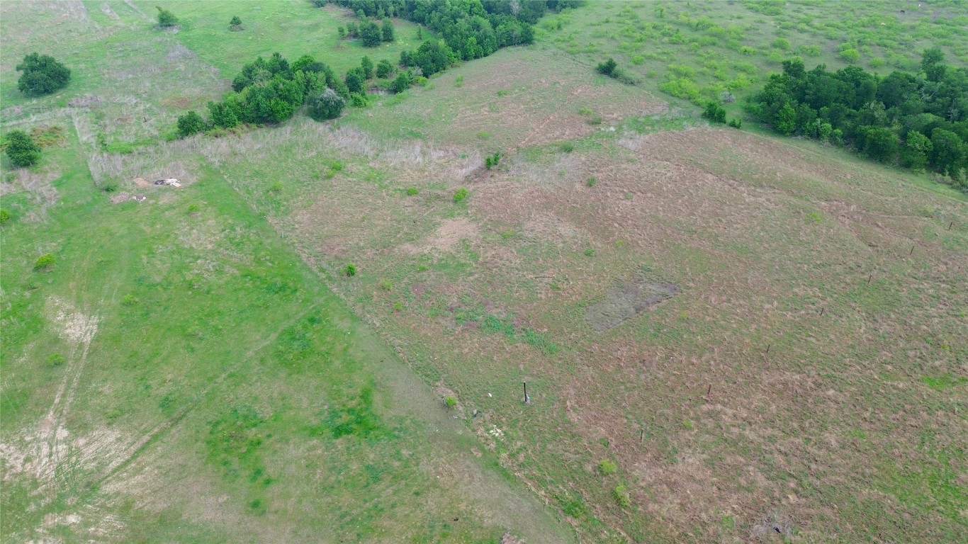 1745 County Road 466 Elgin, TX 78621 - Photo 4 of 7 a view of a dirt road with trees in the background