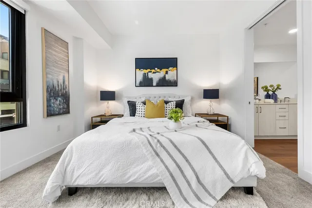 a bedroom with a bed and a lamp with window