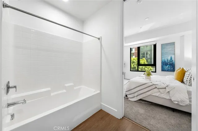 a spacious bedroom with a bed and a chandelier