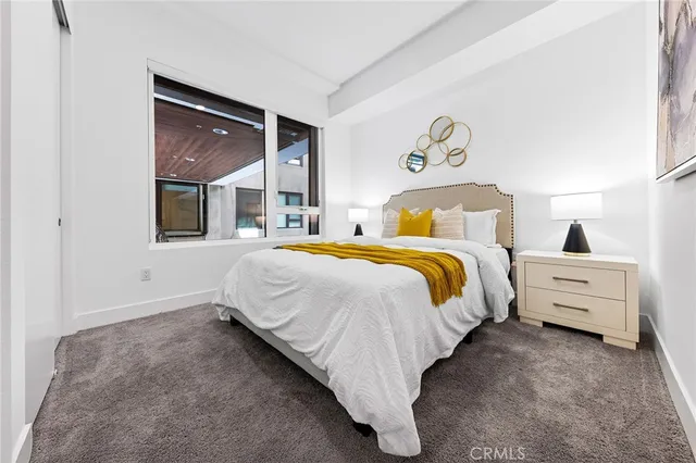 a bed room with a bed and a night stand