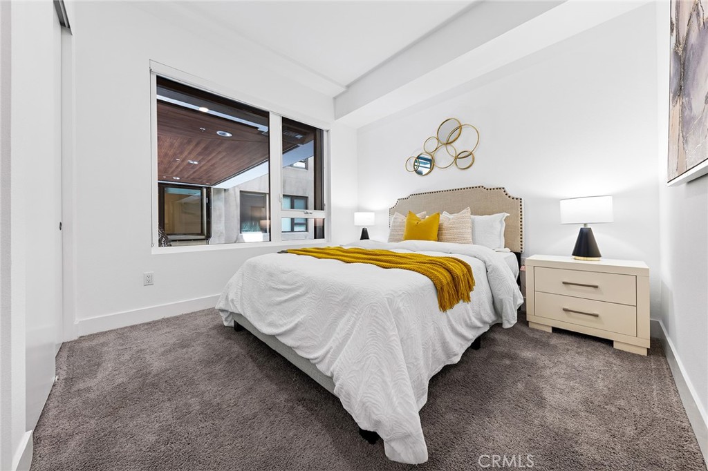 709 East Walnut Street, Unit 227 Pasadena, CA 91101 - Photo 20 of 42 a bed room with a bed and a night stand