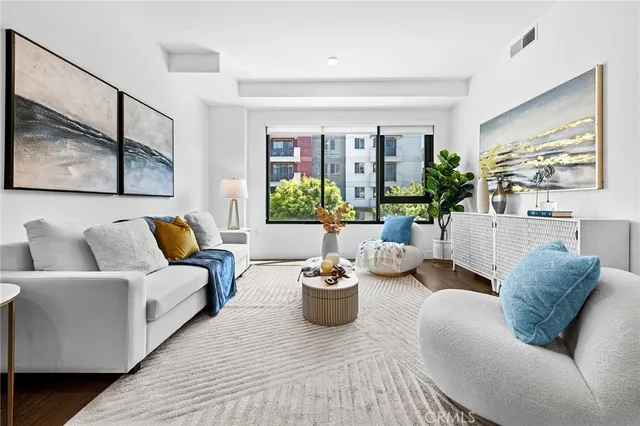 a living room with furniture potted plant and a window
