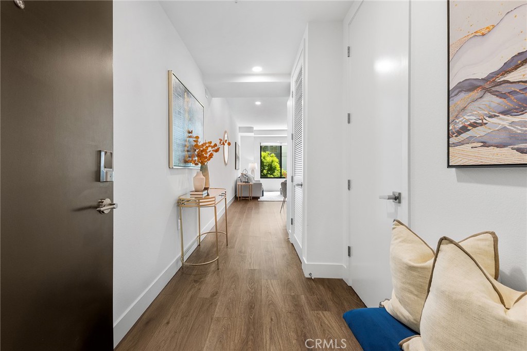 709 East Walnut Street, Unit 227 Pasadena, CA 91101 - Photo 22 of 42 a view of a hallway with wooden floor and furniture