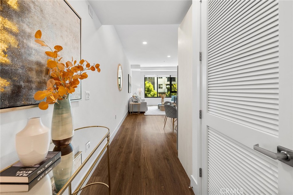 709 East Walnut Street, Unit 227 Pasadena, CA 91101 - Photo 23 of 42 a view of a hallway with wooden floor and a potted plant
