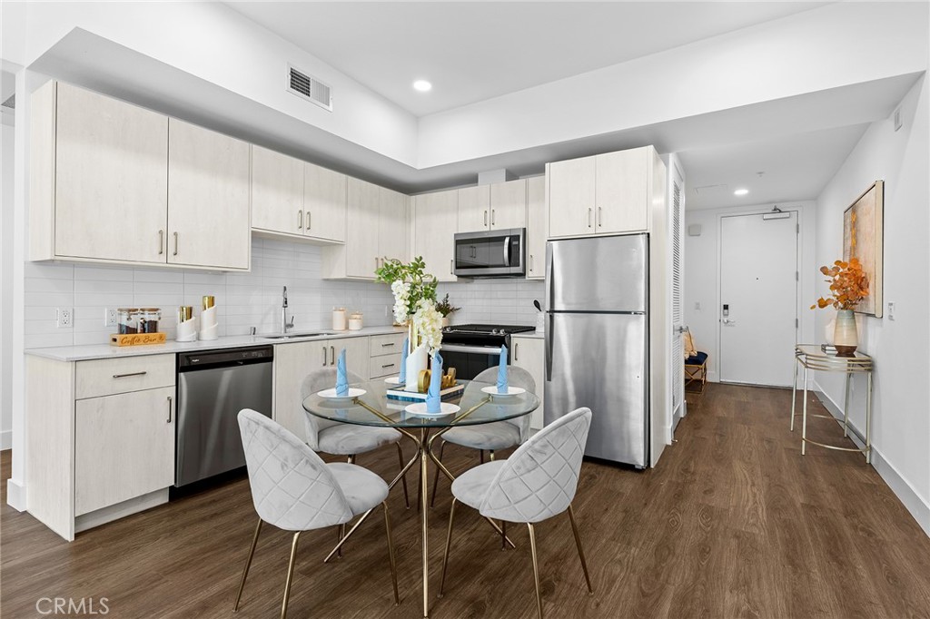 709 East Walnut Street, Unit 227 Pasadena, CA 91101 - Photo 8 of 42 a kitchen with refrigerator cabinets dining table and chairs