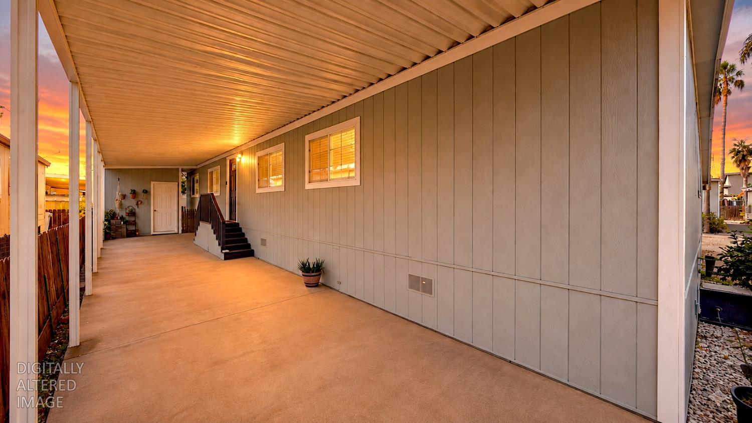 812 West Clover Road, Unit 59 Tracy, CA 95376 - Photo 6 of 51 Expansive covered patio area with a concrete surface, providing ample outdoor space