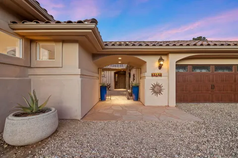 a view of a patio with couches chairs potted plants and floor to ceiling window