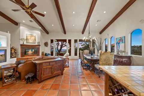 a view of a patio with couches table and chairs and potted plants