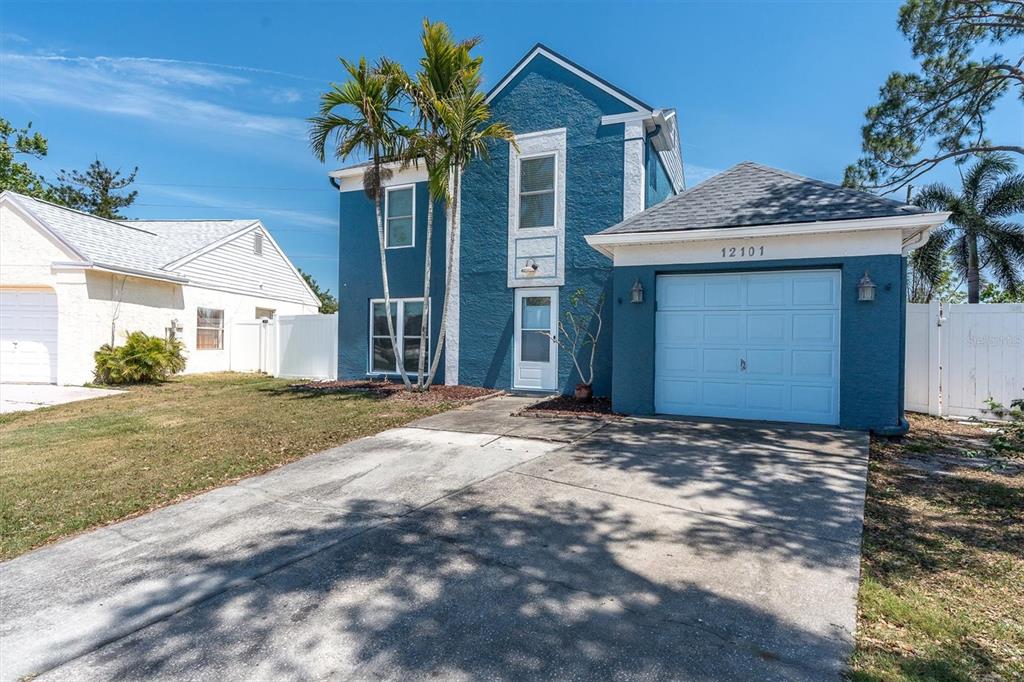 12101 74th Street Largo, FL 33773 - Photo 35 of 36 a view of a house with a yard and garage