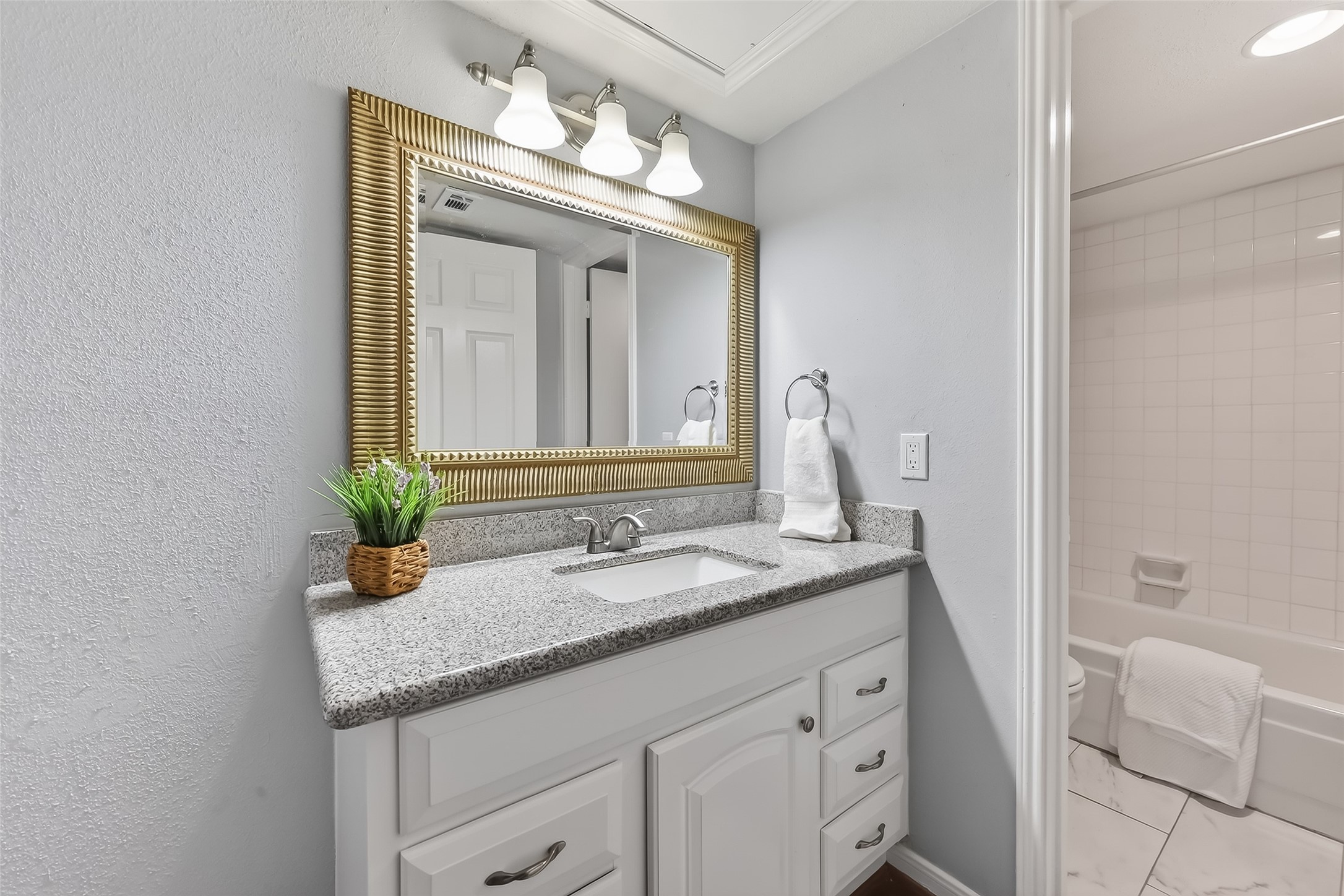 2100 Tanglewilde Street, Unit 740 Houston, TX 77063 - Photo 16 of 40 guest bath vanity with granite counters and freshly painted cabinets
