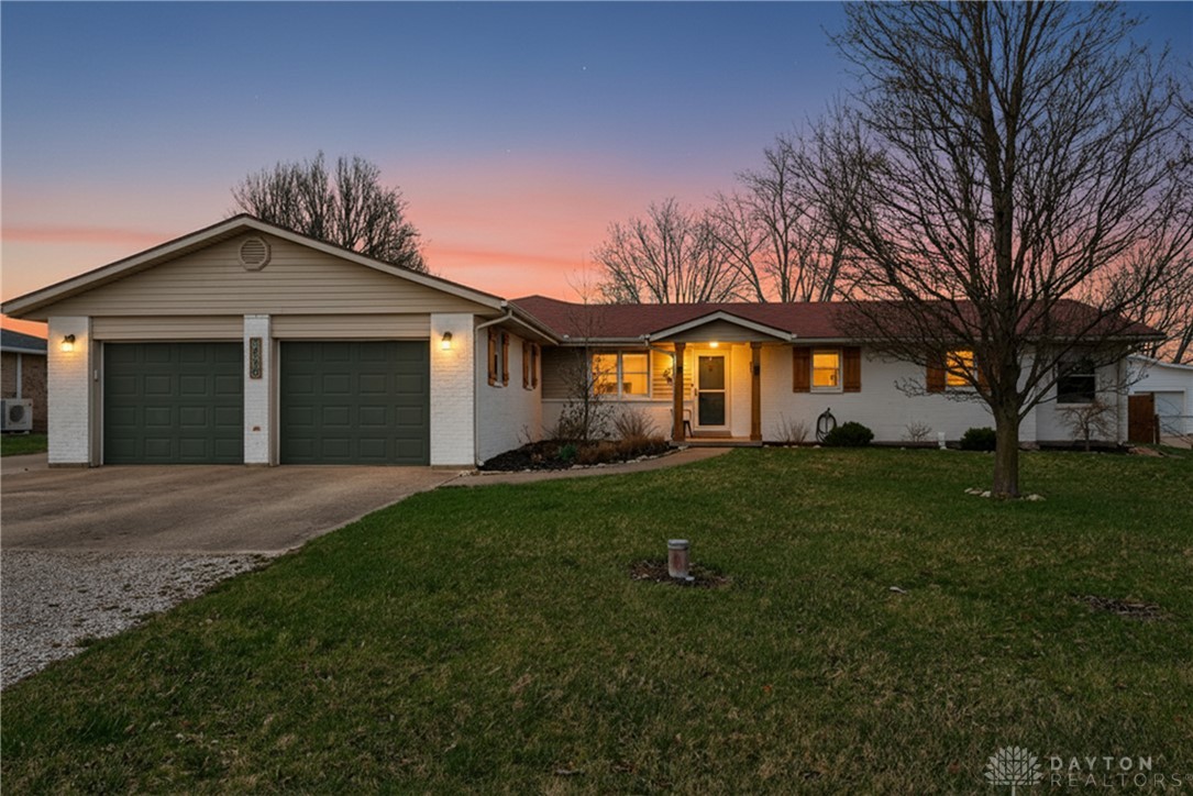 This charming residence offers a welcoming facade with a convenient attached garage.
