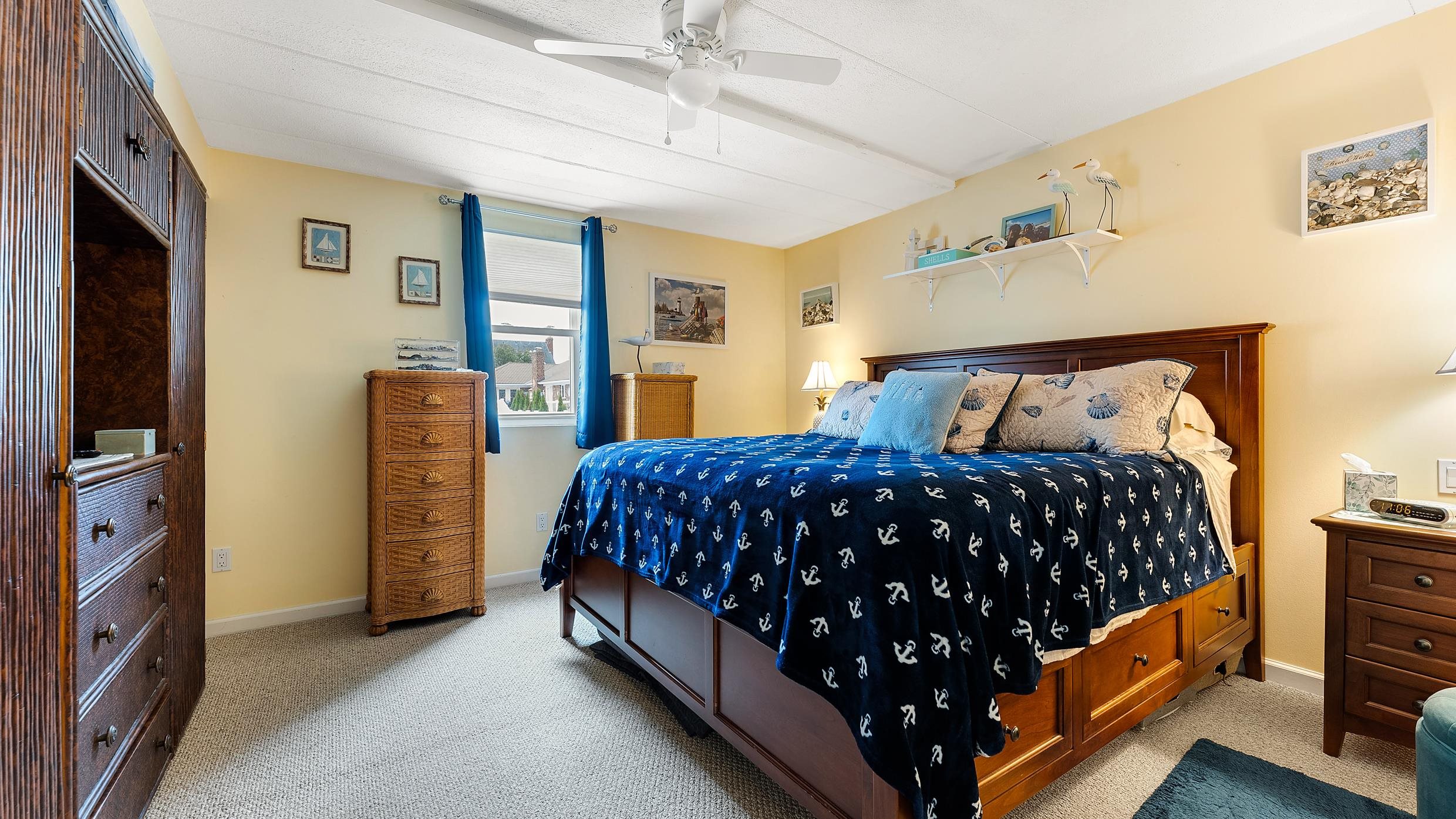 208 East Forget-Me-Not Road, Unit 103 Wildwood Crest, NJ 08260 - Photo 14 of 20 a bedroom with a bed and large window