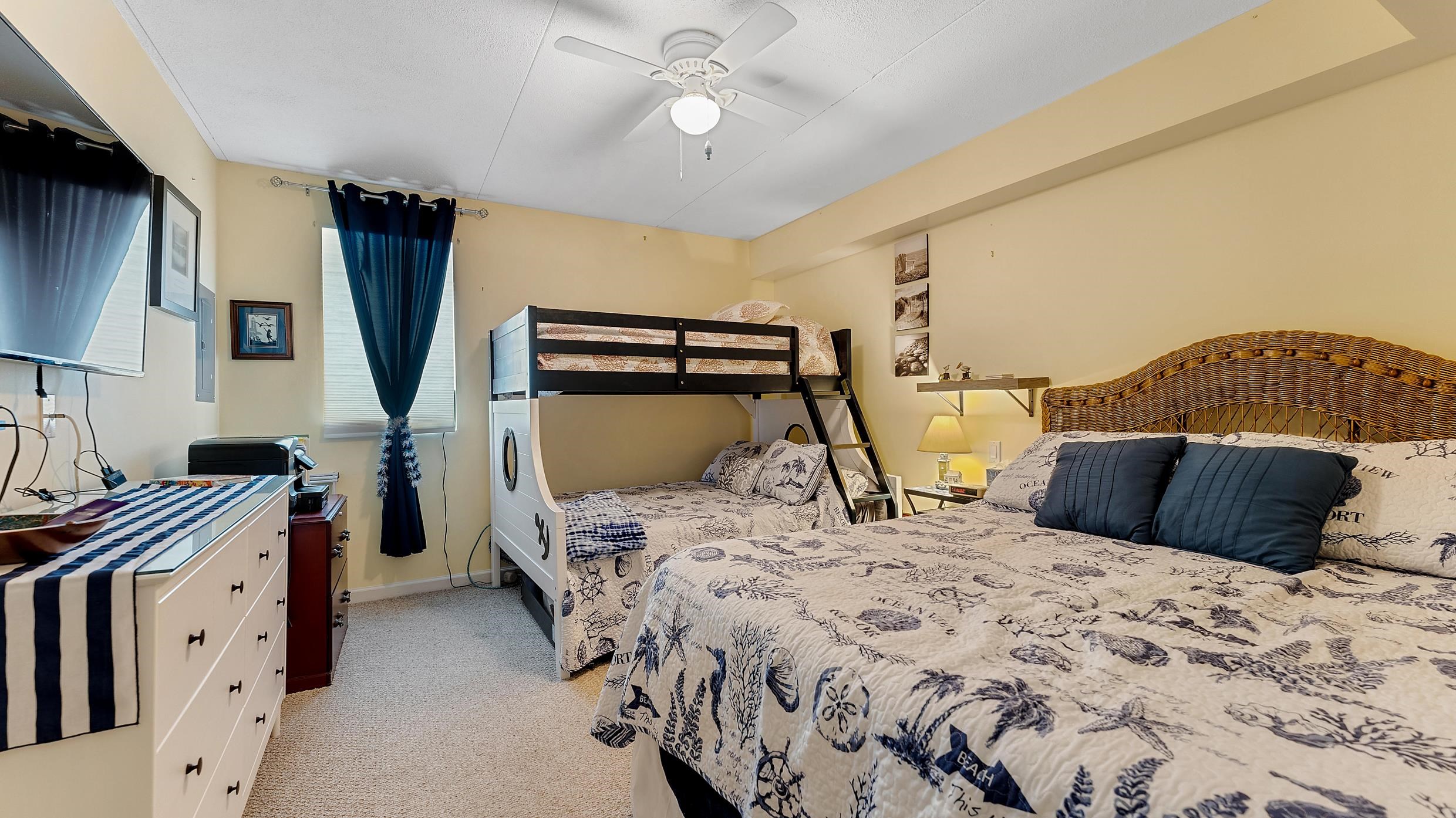 208 East Forget-Me-Not Road, Unit 103 Wildwood Crest, NJ 08260 - Photo 17 of 20 a bedroom with a large bed and a chandelier