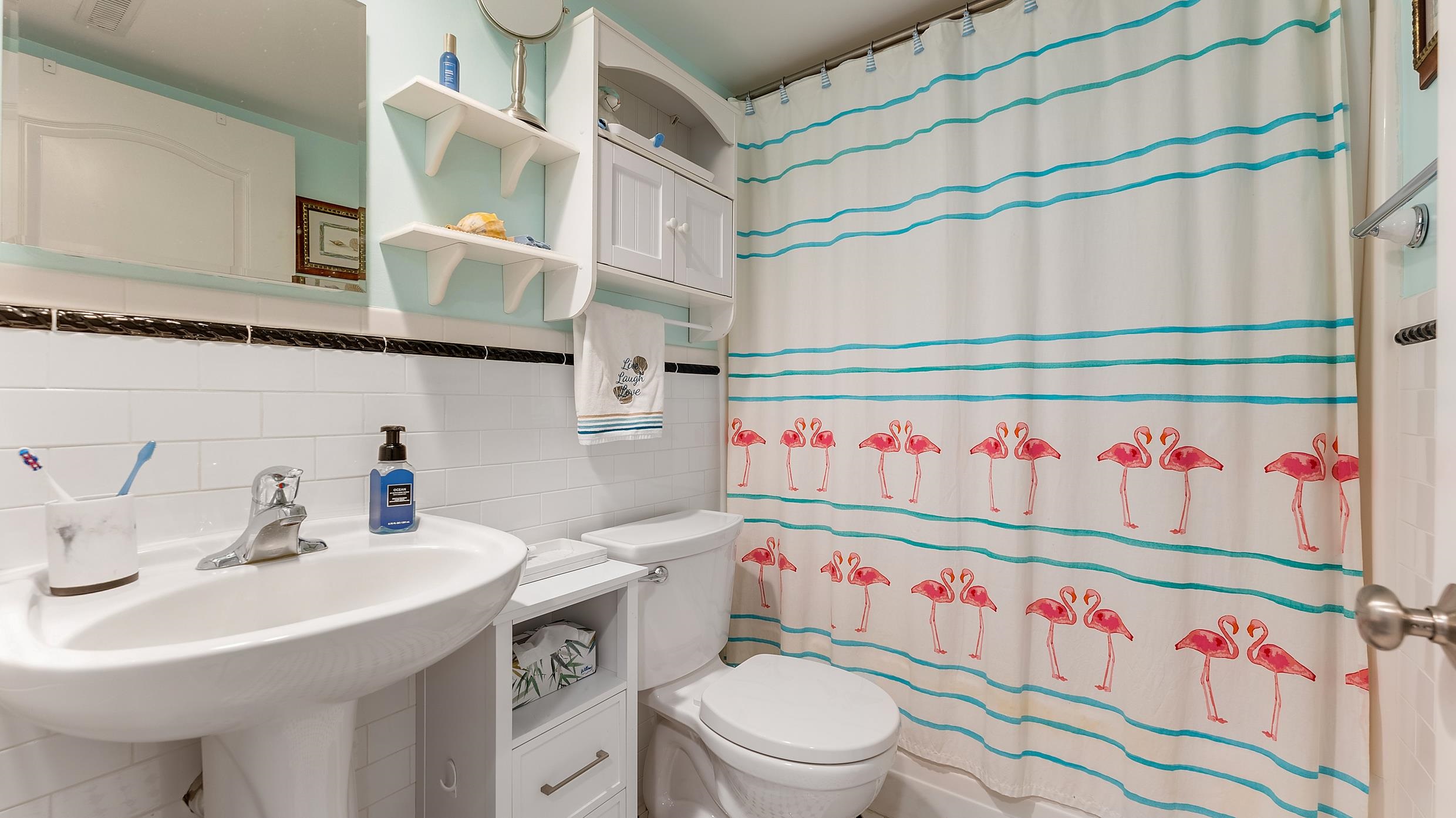 208 East Forget-Me-Not Road, Unit 103 Wildwood Crest, NJ 08260 - Photo 19 of 20 a bathroom with a sink a toilet and a shower curtain