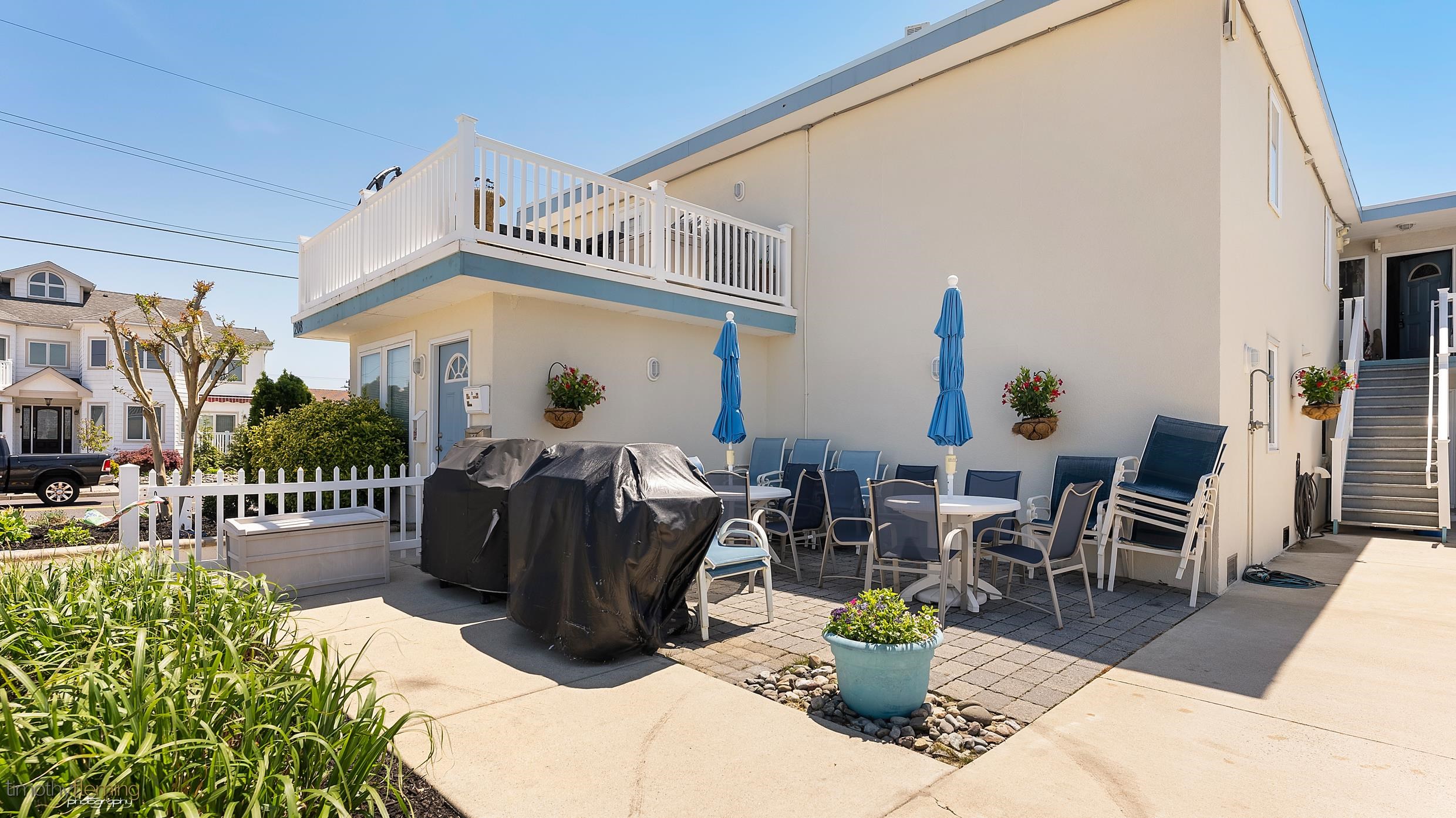 208 East Forget-Me-Not Road, Unit 103 Wildwood Crest, NJ 08260 - Photo 3 of 20 a view of a patio with a table and chairs