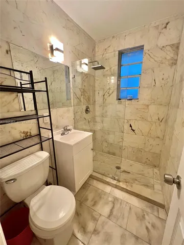 a bathroom with a toilet sink and shower