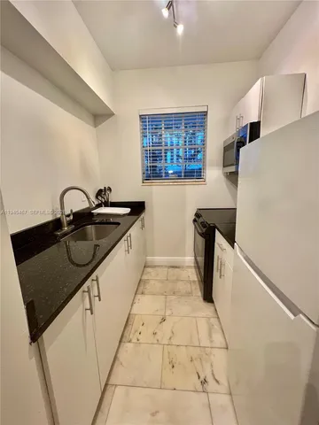a kitchen with a sink a stove and refrigerator