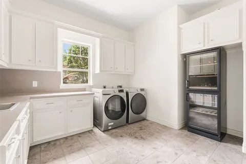 a spacious bathroom with a double vanity sink mirror and bathtub