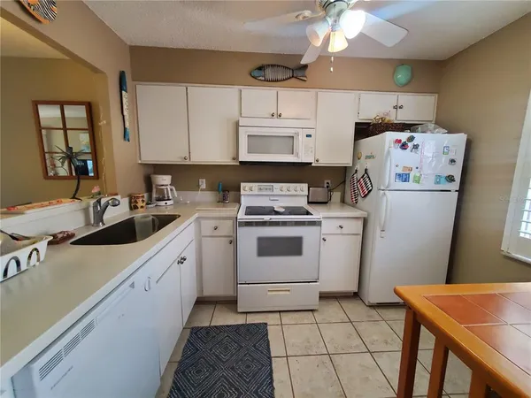 a kitchen with a sink a stove and cabinets