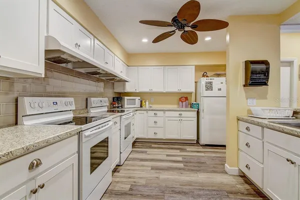 a kitchen with a stove cabinets and a window