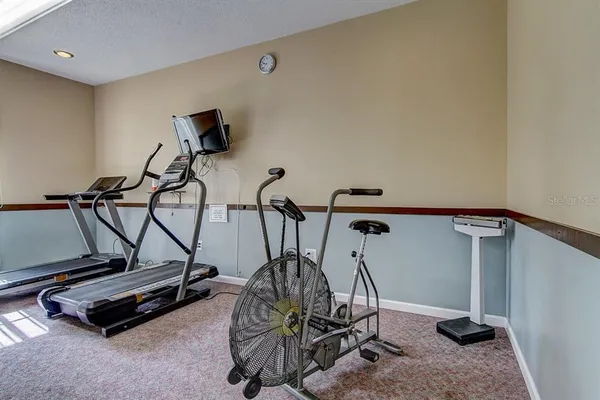 a room with gym equipment and windows