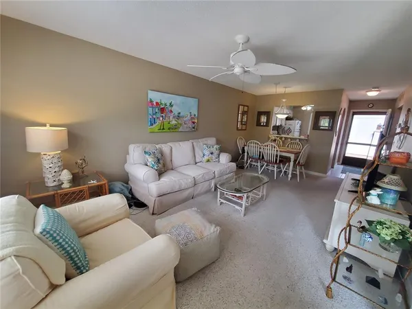 a living room with furniture and a dining table