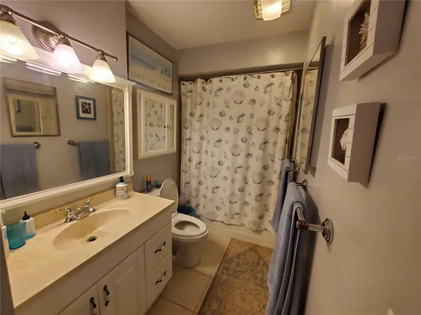 a bathroom with a double vanity sink toilet and shower