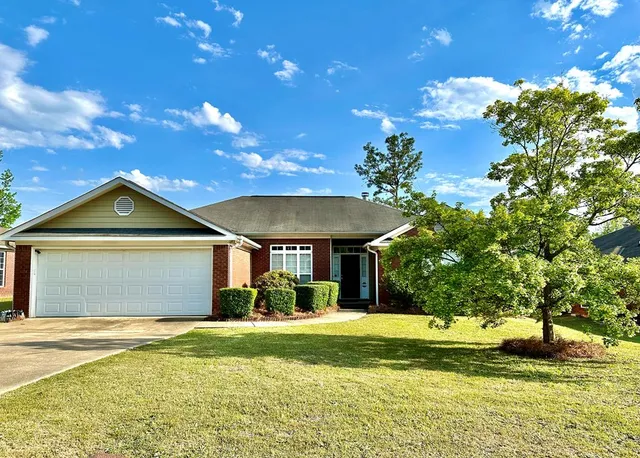 a front view of a house with a garden