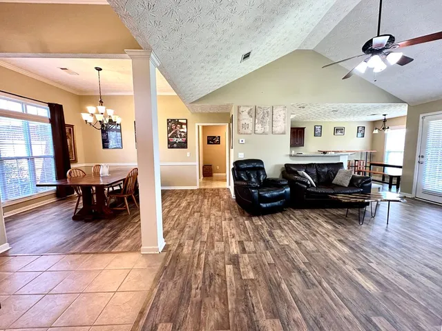 a living room with furniture and wooden floor