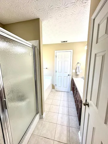 a bathroom with a glass door shower and a mirror