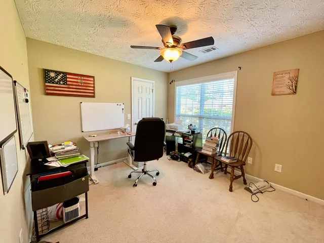 a work room with furniture and windows