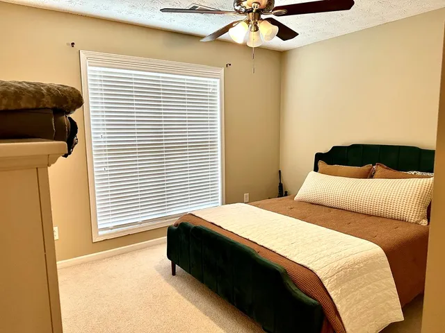 a view of staircase with a rug and a window