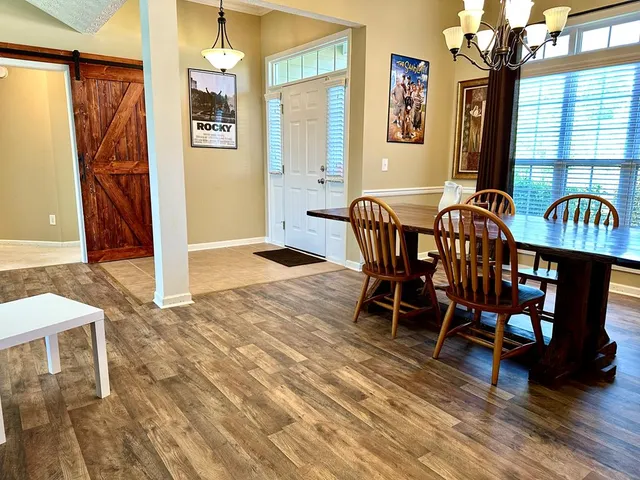a view of a dining room with furniture window and wooden floor