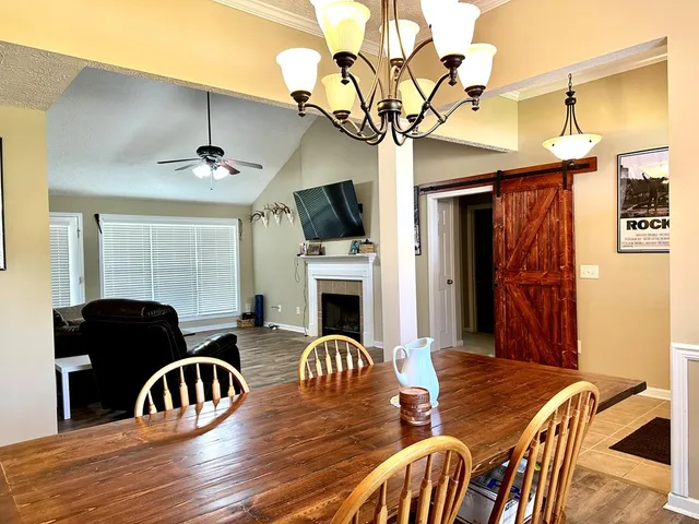 a view of a livingroom with furniture a flat screen tv and couches