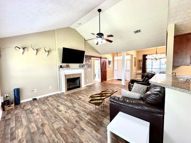 a living room with furniture fireplace and flat screen tv