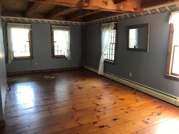 370 Winthrop Street Rehoboth, MA 02769 - Photo 8 of 22 a view of an empty room with wooden floor and a window