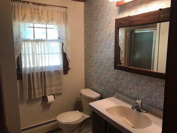 370 Winthrop Street Rehoboth, MA 02769 - Photo 10 of 22 a bathroom with a toilet a sink a mirror and a window