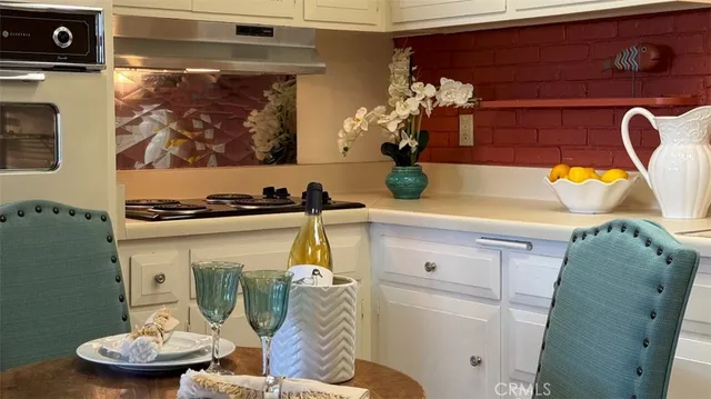 a stove top oven sitting inside of a kitchen