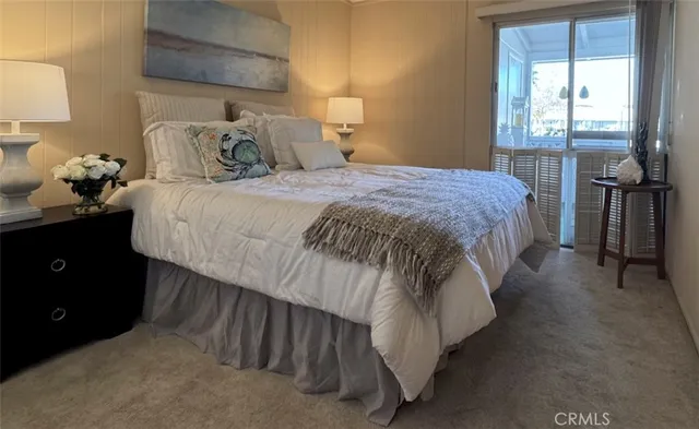 a bedroom with a bed and a lamp on table