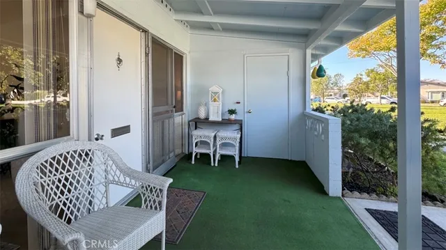 a view of balcony with a table and chairs