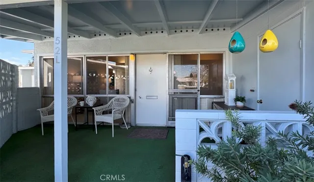 a view of an chairs and table in a patio