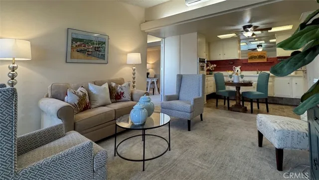 a living room with furniture kitchen view and a table