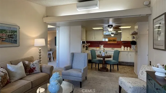 a living room with furniture and a dining table