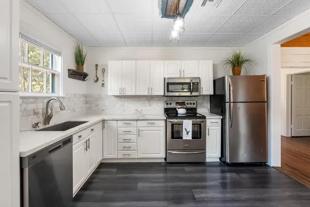a dining room with furniture window and wooden floor