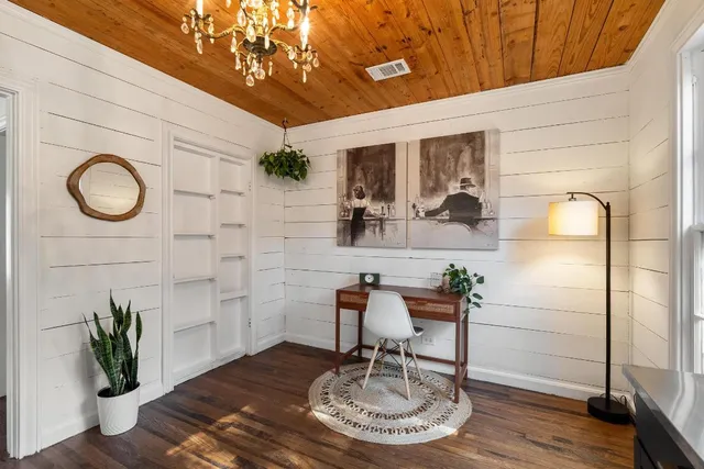 a dining room with table chairs and wooden floor