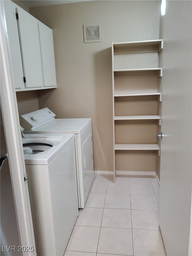 7885 West Flamingo Road, Unit 1064 Las Vegas, NV 89147 - Photo 12 of 19 Clothes washing area with visible vents, baseboards, washer and clothes dryer, cabinet space, and light tile patterned floors