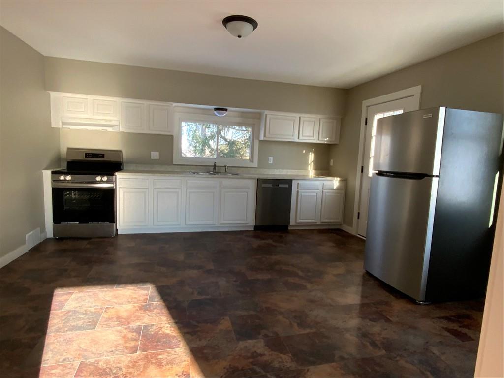 75 Meneely Road Burgettstown, PA 15021 - Photo 4 of 11 a kitchen with a refrigerator and a stove
