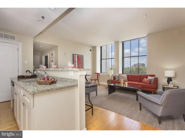 a living room with furniture a window and a sink