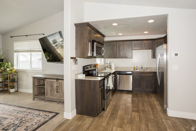 2452 West 500 South, Unit 2 Springville, UT 84663 - Photo 8 of 23 Modern kitchen featuring dark wood-finish cabinetry, stainless steel appliances, light countertops, and wood-finish flooring